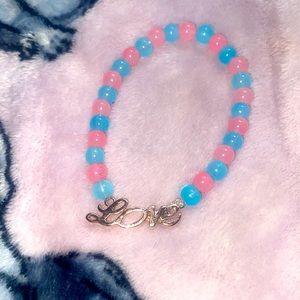 Pink & blue glass bead bracelet w love charm in the center.Home made!💓🩵